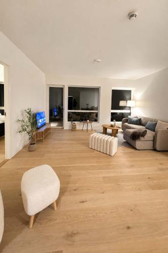 a living room with a couch and a chair at The Nordic - 2BR in Voss - The Voss Collection in Vossevangen