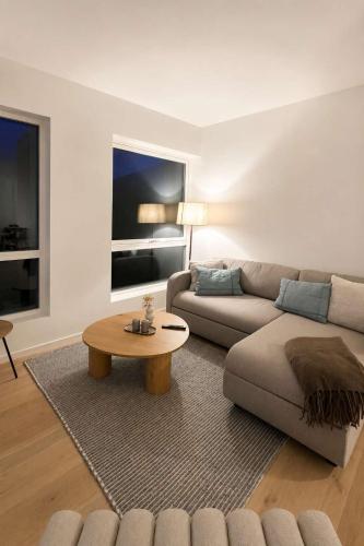 a living room with a couch and a coffee table at The Nordic - 2BR in Voss - The Voss Collection in Vossevangen