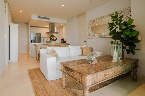 a living room with a white couch and a table at Modern apt with 2 BR BBQ and views in Cartagena de Indias