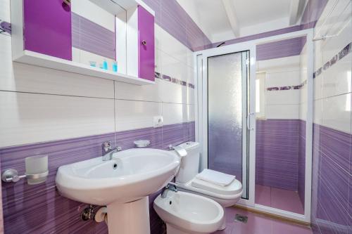 a bathroom with a sink and a toilet at Blue Stay Boutique Hotel in Himare
