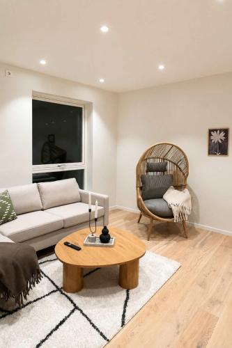 a living room with a couch and a chair at The View - 4BR Central Voss - The Voss Collection in Vossevangen