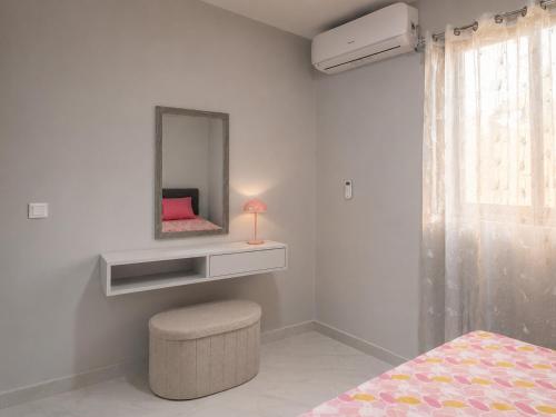 a bedroom with a mirror and a stool and a bed at Portal de Santa Maria in Santa Maria