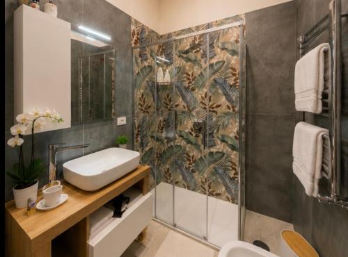 a bathroom with a sink and a shower at Nigalù House in Naples