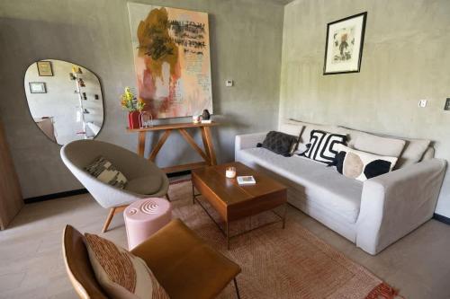 a living room with a white couch and a table at Interior designers second home FREE BIKES in Tulum