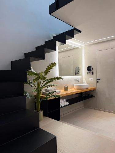 a bathroom with a sink and a staircase at Tradomari in Mesagne