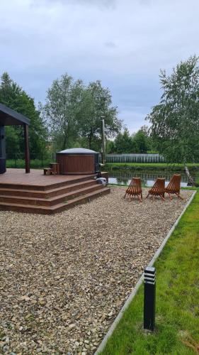 a group of chairs and a gazebo in a park at SHKLO Lake&SPA in Shklo