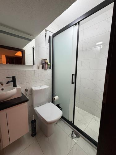 a bathroom with a toilet and a glass shower at Saymon apartment Trpejca in Ohrid