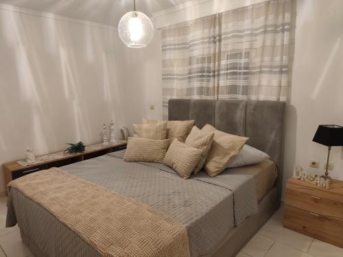 a bedroom with a bed with pillows on it at Panora House in Kefalos