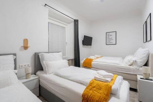 two beds in a room with a mirror at Quiet - 4 Guests - Self Check-in - Netflix - 35m2 in Leoben