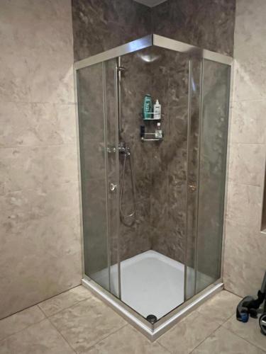 a shower with a glass door in a bathroom at Rus House in Cluj-Napoca