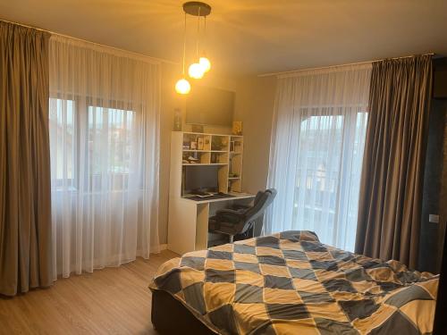 a bedroom with a bed and a desk with a computer at Rus House in Cluj-Napoca
