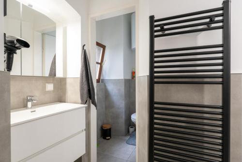 a bathroom with a sink and a mirror at Coyhomes Steyr Riverside - Serviced Apartments in Steyr