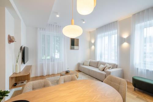 a living room with a table and a couch at Unique apartment with all comforts and sauna in Otepää