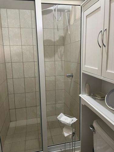 a shower with a glass door in a bathroom at Gasakam in San Pedro Sula