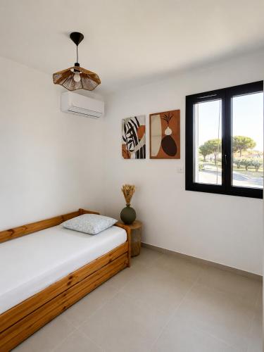 a bedroom with a bed and a window at La villa Bern in Sorgues