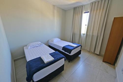 En eller flere senge i et værelse på Hotel Flat Ipatinga