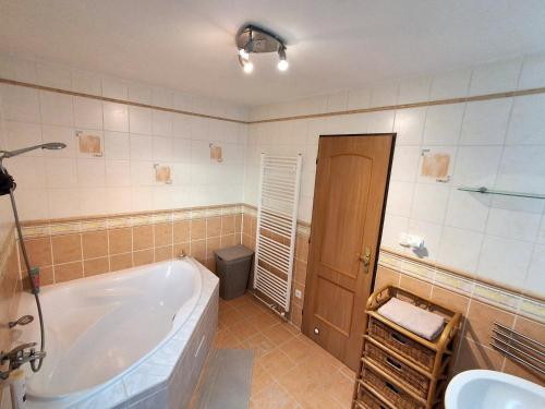 a bathroom with a tub and a sink at Vila na Skalce in Česká Kamenice