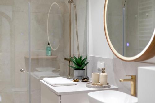 a white bathroom with two sinks and a mirror at Luxorious Japandi design apartment in Otepää