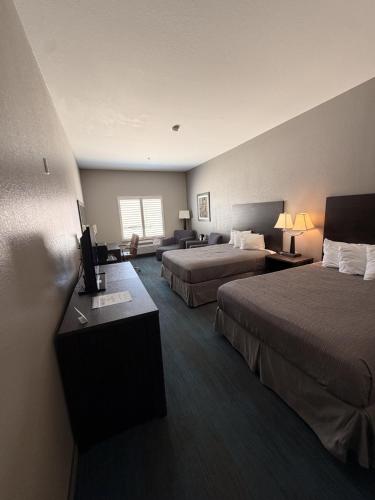a hotel room with two beds and a television at Sagebrush Hotel in Crystal City