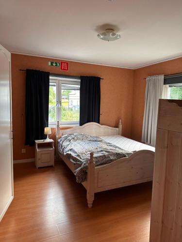 a bedroom with a bed and a window at Härjulfs hus in Lillhärdal