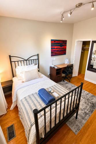 a bedroom with a large bed and a desk at North York Quiet Room#2 in Toronto
