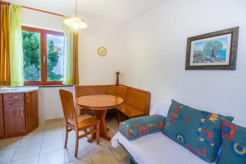 a living room with a couch and a table at Marija Big & Comfortable in Baška
