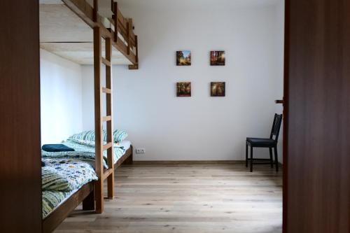 a bedroom with two bunk beds and a staircase at Apartman Sysl in Ricany