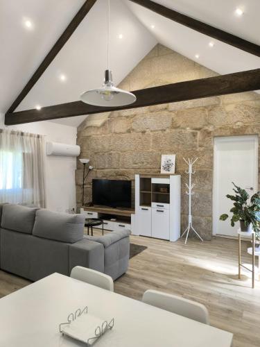 a living room with a stone wall at Casa Fontenlos in Tui