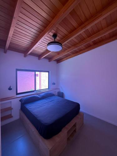 a bedroom with a large bed with a wooden ceiling at La Rosadita in Concordia