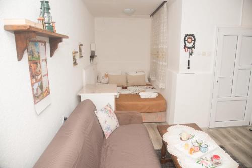 a living room with a couch and two beds at Rečni Povetarac in Niš