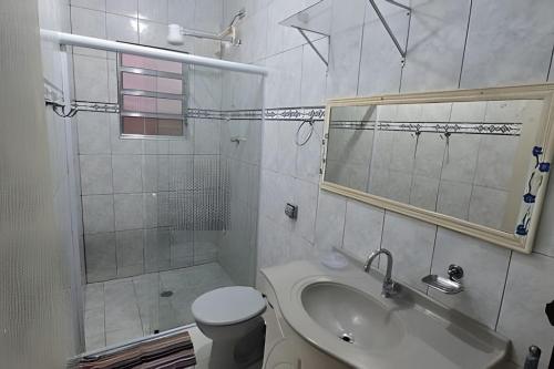 a bathroom with a sink and a toilet and a shower at Chalé Private c/ Vista e garagem in Ilhabela