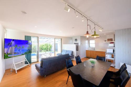 a living room with a dining room table and a kitchen at Pool Villa Mito - Pool Villa 水戸 in Mito