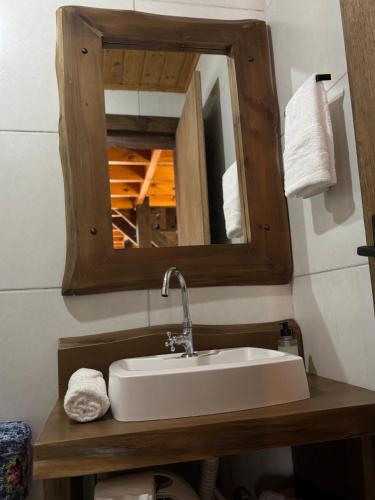 a bathroom with a sink and a mirror at Cabanas em Canela - Leão da Tribo de Judá- Refúgio com Piscina in Canela