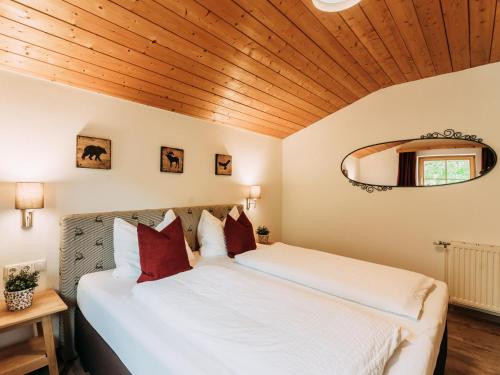 a bedroom with a large bed and a wooden ceiling at Barney in Rauris