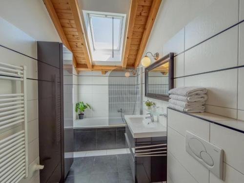 a bathroom with a sink and a tub and a mirror at Kötschach in Kötschach