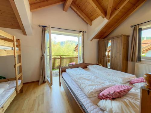 a bedroom with a bed and a large window at Kötschach in Kötschach