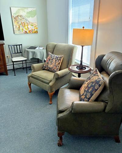a living room with two chairs and a couch at Bristol Suites in Bristol