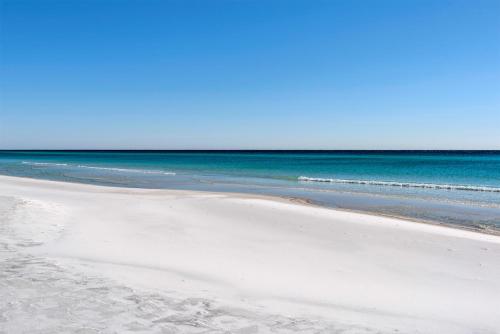 an empty beach with the ocean in the background at Sea Oats Motel in Destin