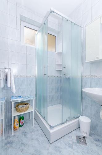 a bathroom with a shower and a toilet and a sink at Apartments Emmas studio in Stari Grad