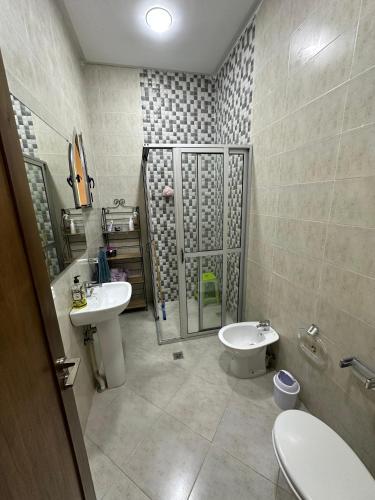 a bathroom with a sink and a toilet and a shower at jnan Lemonie in Asilah