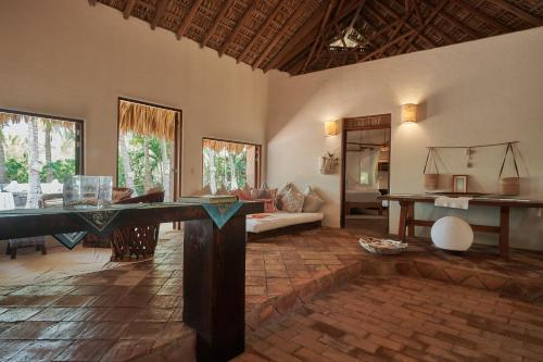 a living room with a table in the middle of a room at Casa Macagua in El Puertecito