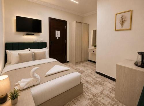 a hotel room with two beds with a swan on it at ImhOtep pYramids HOtel in Cairo