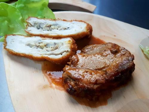 a plate of food with a piece of bread and meat at Hanul Lui Bogdan Economy INN in Făget