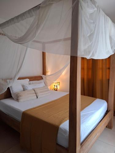 a bedroom with a bed with a canopy at Chalet vue mer, piscine in Saint-Claude