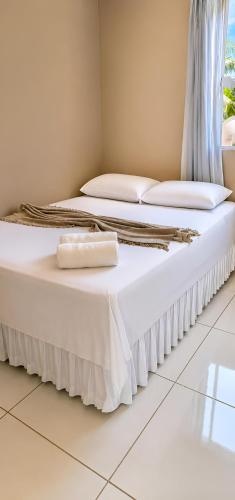 two beds with white sheets and pillows in a room at Ap Harmonia Bg in Barra Grande