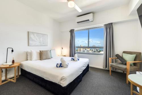 a hotel room with a large bed and a window at 15th Floor Superior Hotel Suite King Bed in Darwin