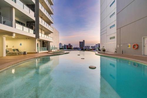 a swimming pool in the middle of a building at 15th Floor Superior Hotel Suite King Bed in Darwin