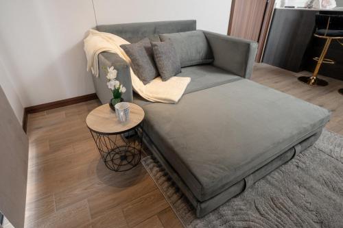 a gray couch in a living room with a table at 1503 A - INARA Downtown Four in Guatemala