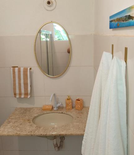 a bathroom with a sink and a mirror at Solar das pérolas Búzios 1 in Búzios