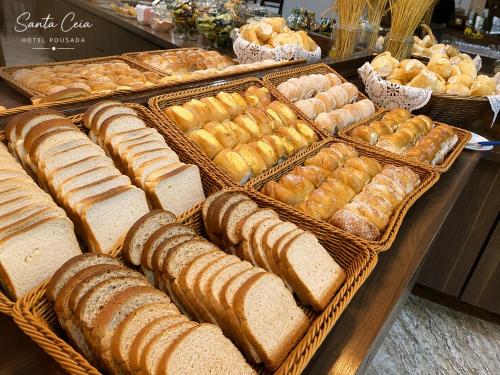 a display of bread and pastries on a table at Hotel Pousada Santa Ceia in Aparecida